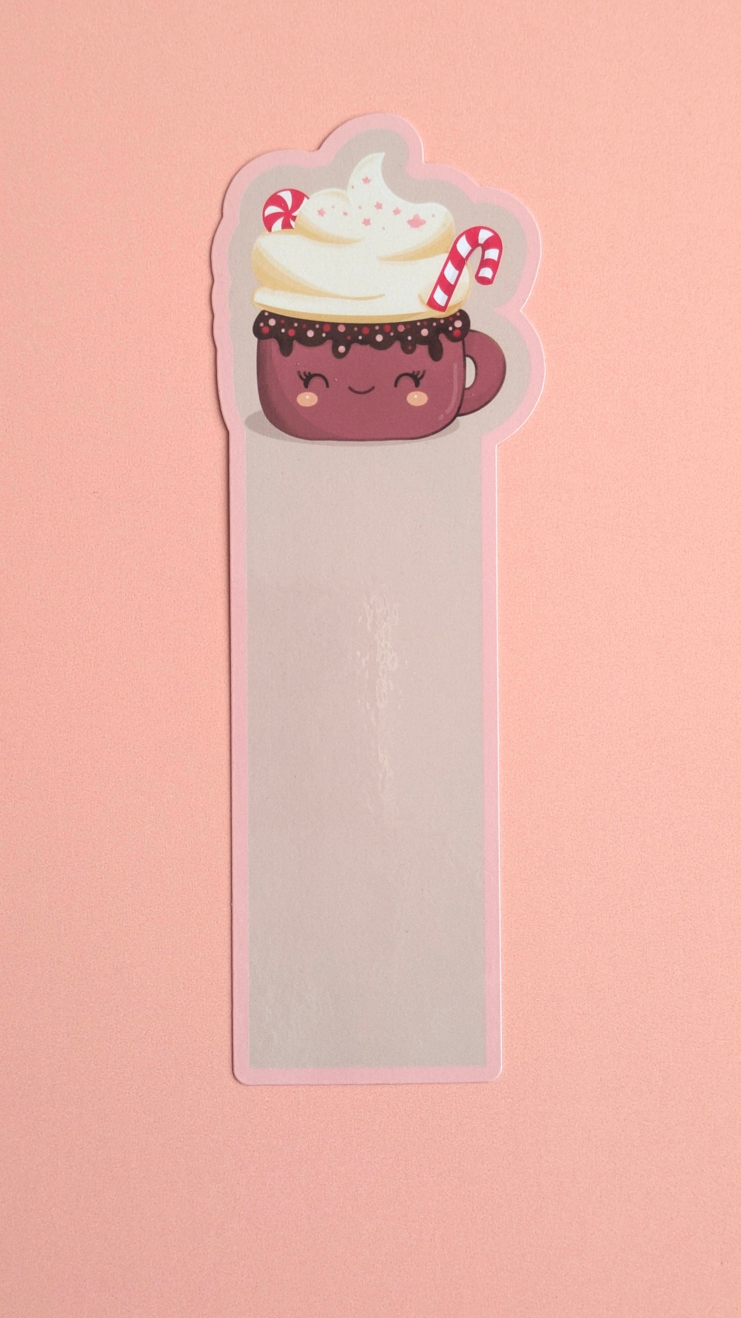 Kawaii peppermint hot chocolate gloss bookmark with soft pink pastel border, whipped cream and candy cane — Peppermint Dream holiday design on a neutral background.