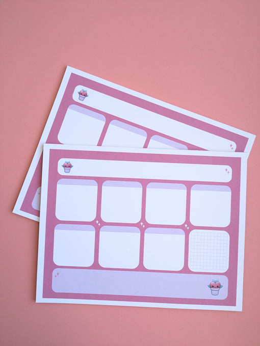 Ariel image of two 'Lil Buddy' weekly planner notepads laid at an over each other on a pink background.