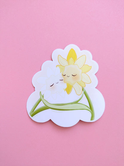 Ateu Studio Daffodil Hug SZN gloss vinyl sticker featuring cute yellow floral characters on a vibrant pink background. This clear, high-fidelity product shot showcases the original character art and spring aesthetic colors.