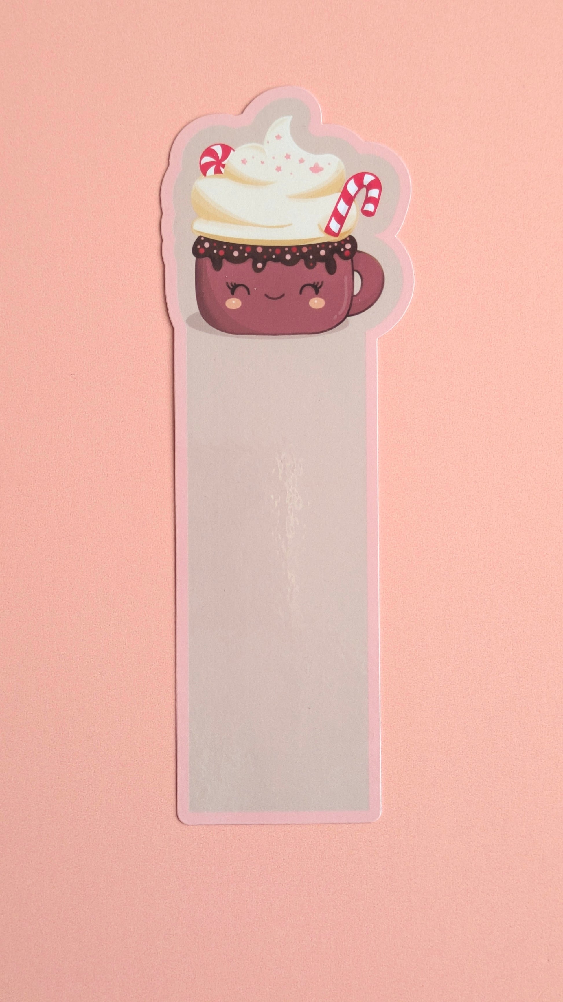 Kawaii peppermint hot chocolate gloss bookmark with soft pink pastel border, whipped cream and candy cane — Peppermint Dream holiday design on a neutral background. 