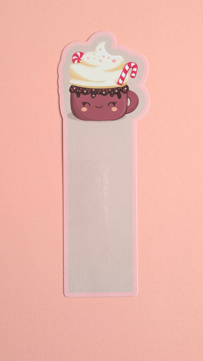Kawaii peppermint hot chocolate gloss bookmark with soft pink pastel border, whipped cream and candy cane — Peppermint Dream holiday design on a neutral background. 