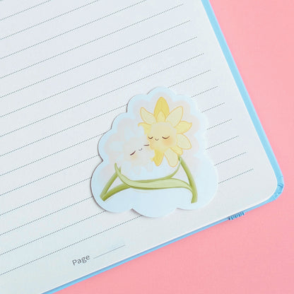 Ateu Studio Daffodil Hug SZN character sticker decorating a pale lavender lined journal page. This aerial shot captures the high-fidelity art and clean-peel quality, perfect for spring-themed book annotating and aesthetic stationery setups.