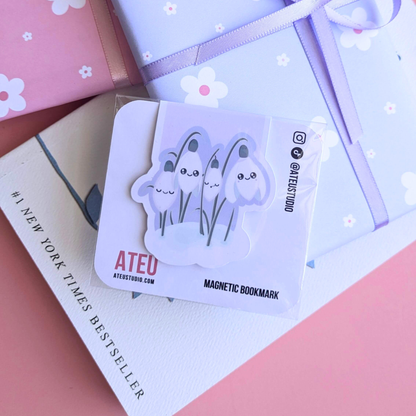 A close-up view of the Ateu Studio Kawaii Sleepy Snowdrop 'Dawn' Lavender Blue magnetic bookmark on its branded backing card. The retail packaging shows the Kawaii character art clearly, with a soft light reflection. This shot highlights the premium presentation designed for aesthetic planning and book-safe decorating -&nbsp;an essential, book safe gift add-on for curated literary bundles.