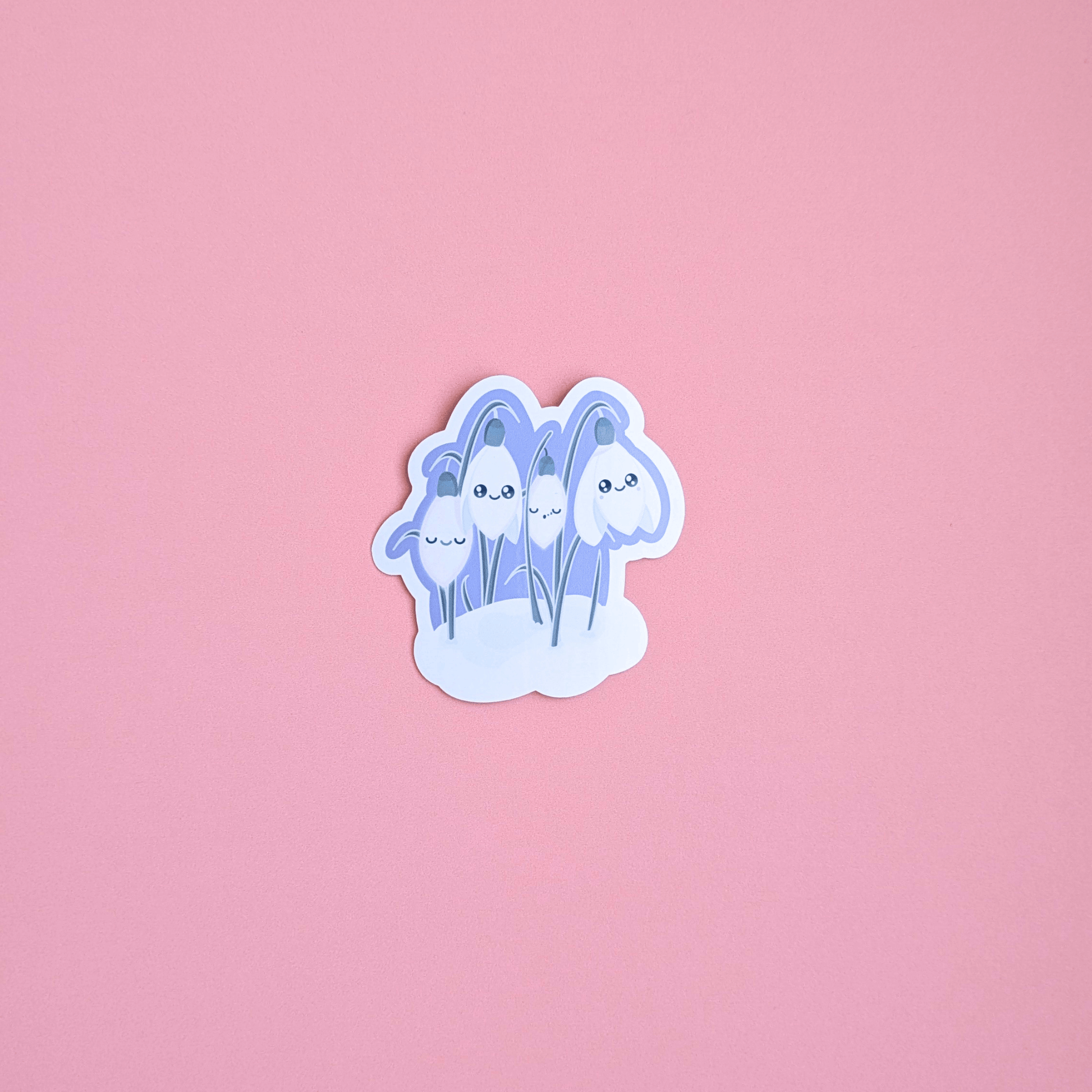 Ateu Studio Sleepy Snowdrop sticker in the 'Midnight Mist' lavender blue colorway, featuring Snowdrop White characters with sage-silver leaves. The cool teal sky palette is shown in an aerial close-up, highlighting the soft-glow effect and quintessential Kawaii faces perfect for winter-themed Kindle decorating.